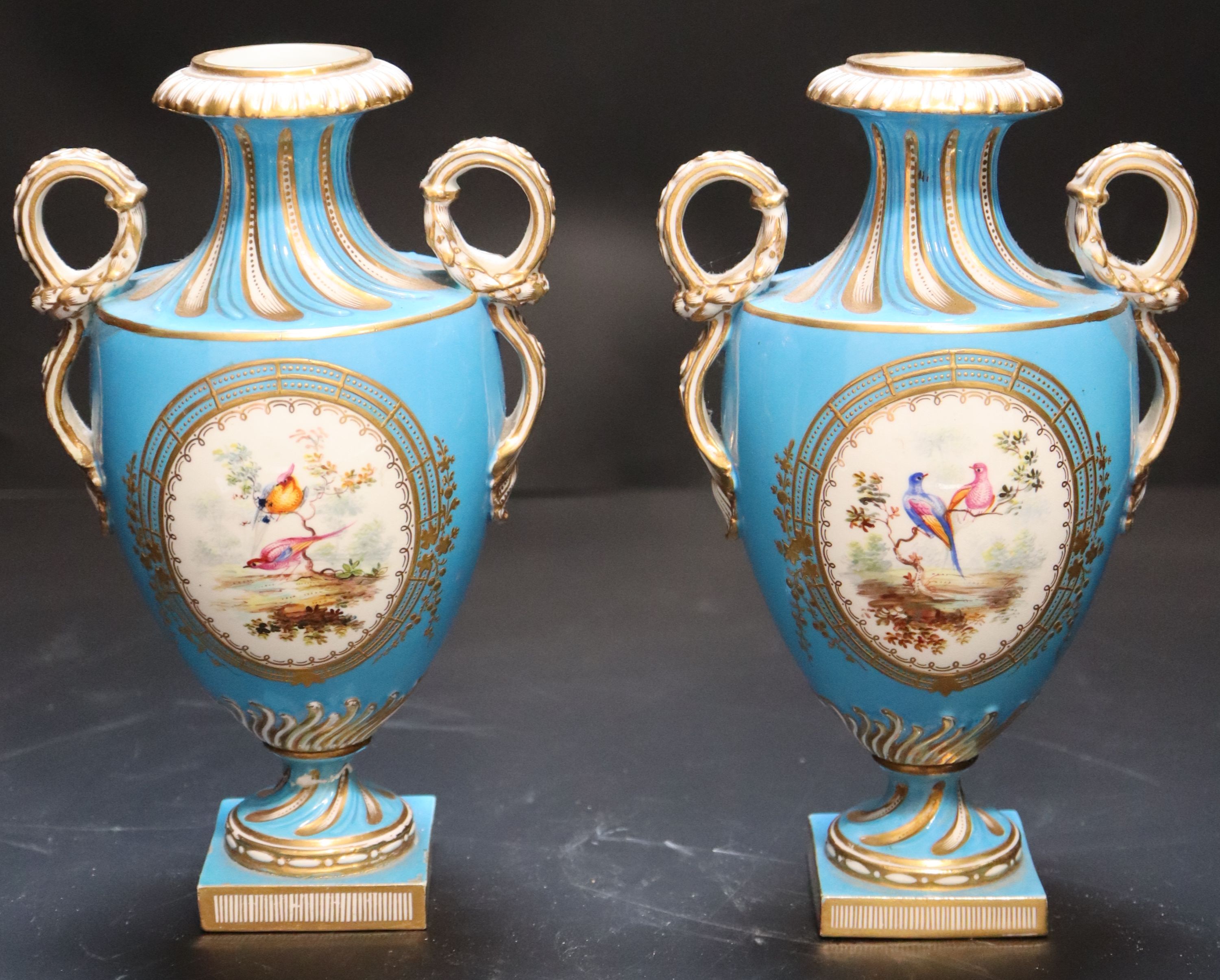 A pair of mid 19th century Coalport turquoise ground two handled vases, height 21cm.